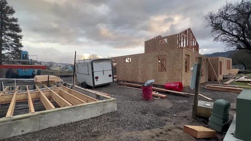 Remolque, cemento y madera en una obra de construcción.