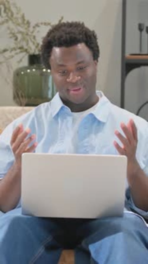 Man Using Laptop for Video Call at Home