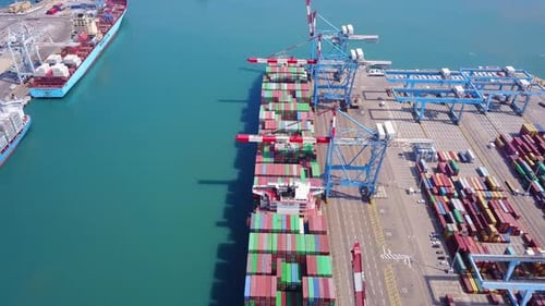 Commercial port with container ships - Top down aerial view.