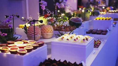 an array of beautiful pastries, artfully arranged on a pristine white table - a feast for the eyes a