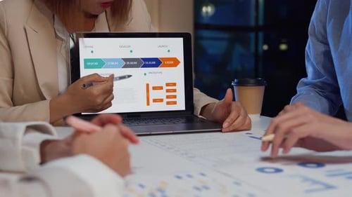 Closeup businesspeople meeting plan analysis statistics brainstorm at office night.