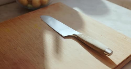 Sharp chef's knife resting on wooden cutting board