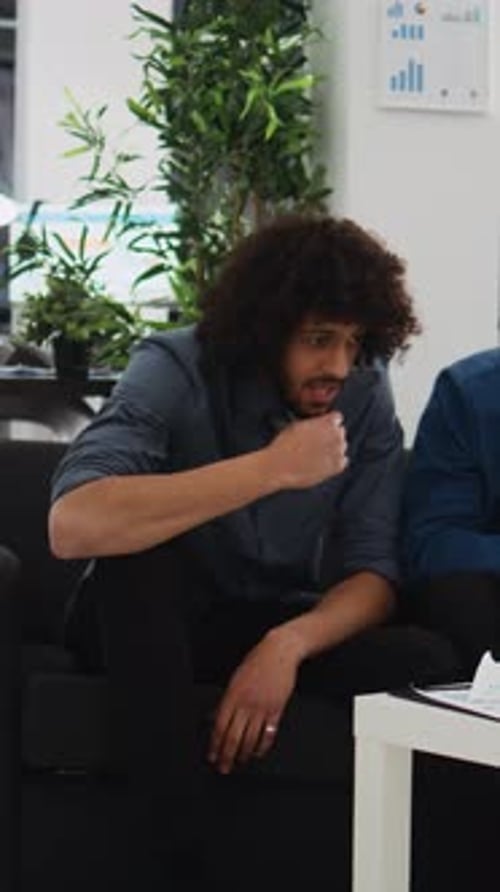 Two Men Discussing Business in Modern Office