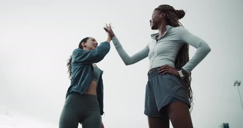 Runner, laugh and high five with women in city for workout partner, health and training goal