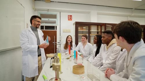 Science Teacher Explains Experiment to Students in Classroom