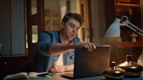 Man Working Late at Night on Laptop