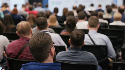 Audience Listening to Presentation at a Corporate Conference