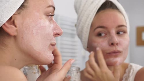 Woman Apply Mask Cream On Face