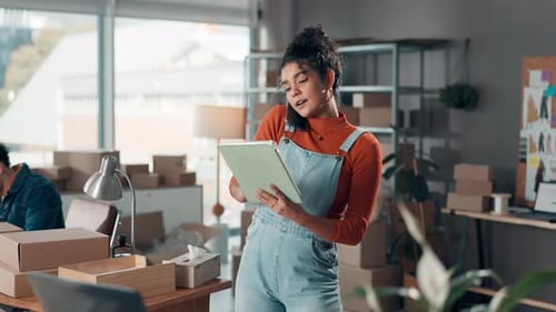 Young Woman Talking on Phone in Shipping Office