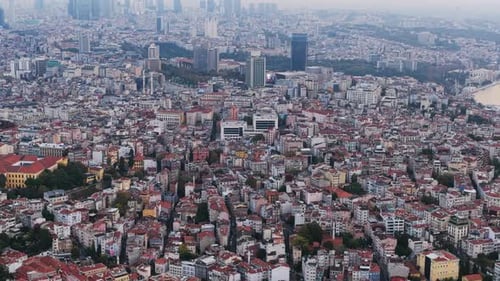 A vast panoramic view of Istanbul showing dense housing, modern buildings, and the city stretching
