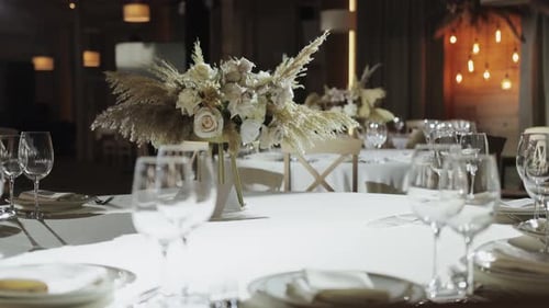 Elegant Table Setting at Wedding Reception with Floral Arrangements