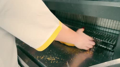 Female Hands Packing Sliced Bread After Automatic Slicing in Indoor Factory The Process of