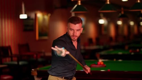 Man Lines Up Pool Shot in Billiards Room