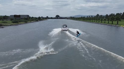 Aerial view of a wakeboarding sport boat practice on the lake with calm water