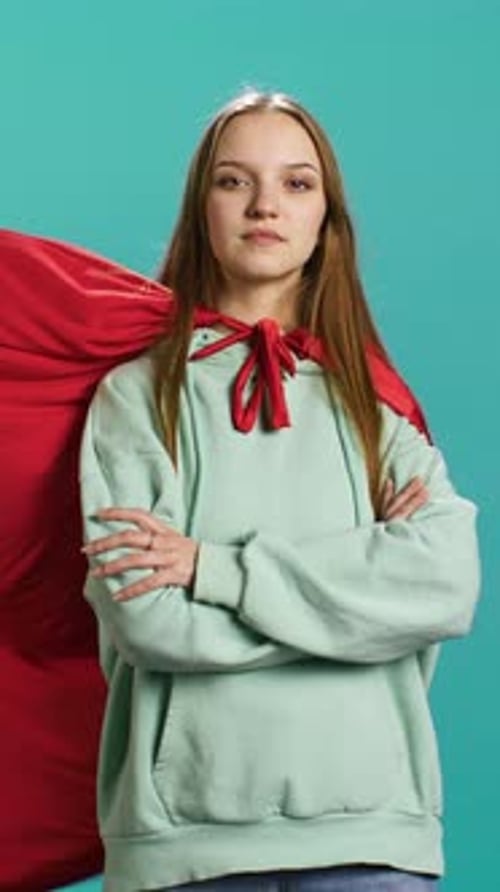 Vertical Video Happy Young Girl Portraying Superhero Flying with Cape Fluttering in Wind