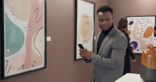 Art, phone and man with photography in gallery for artwork exhibition, creative appreciation