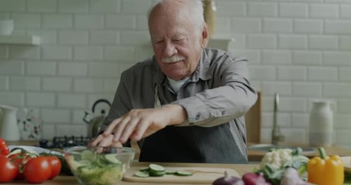 Senior Adult Preparing a Salad in Kitchen