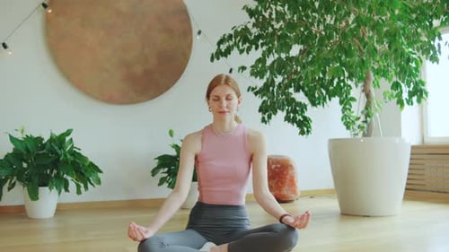 Woman Meditating Peacefully Indoors