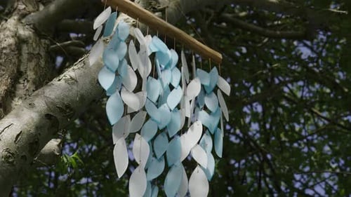 Wind Chime Floating In Wind On Green Tree, Close Up Slow Motion
