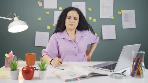 Female student suffering from back pain.