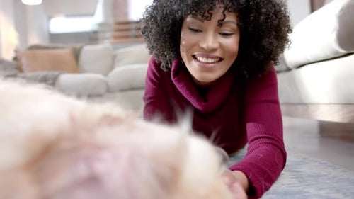 Woman Puts Dog on Floor in Living Room