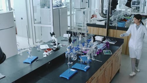 Asian Female Chemical Laboratory Employee Performing Experiment