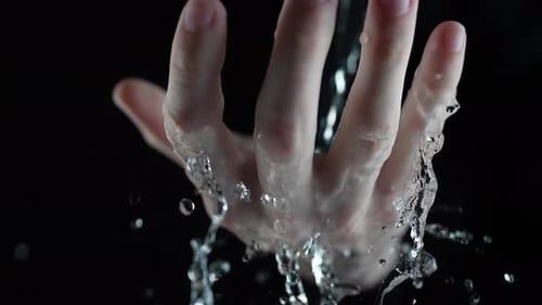 Hand Clenches into Fist as Water Pours Over