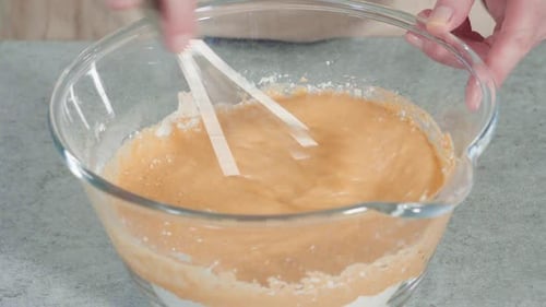Mixing Batter with a Whisk in Glass Bowl