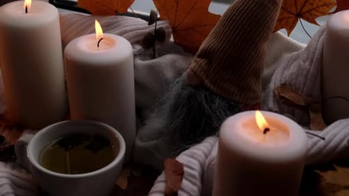 Cozy Still Life with Candles, Tea, and Autumn Decor