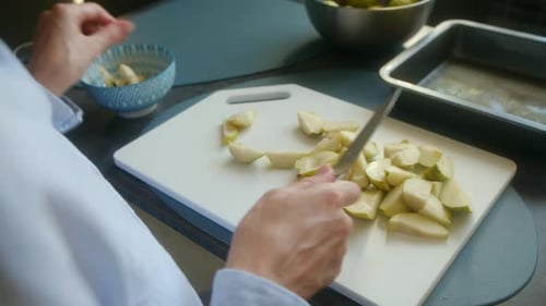 Professional Chef Slicing Fresh Pears on a Cutting Board
