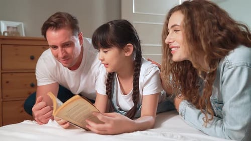 Happy Family Reading a Book Together Indoors
