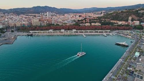 Malaga cityscape across the harbor at nightfall