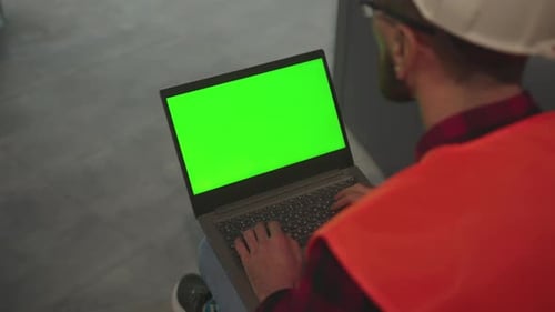 Top View Hands Engineer Using Laptop Computer with Green Screen Inside Building Worker Project