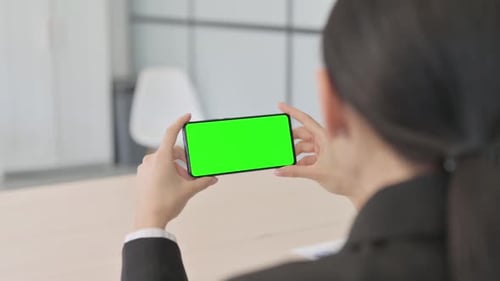 Businesswoman with Green Screen Smartphone in Hands