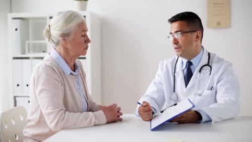 Senior Woman Consults Doctor in White Office