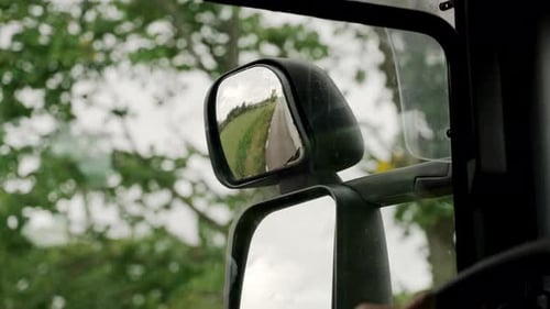 Close up mirror glass reflection reflective open fields side viewing angle truck bus driver driving