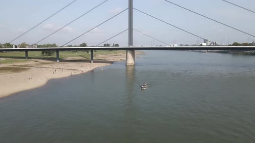 Aerial view of small boat cruising on Rhine river, Dusseldorf, Germany