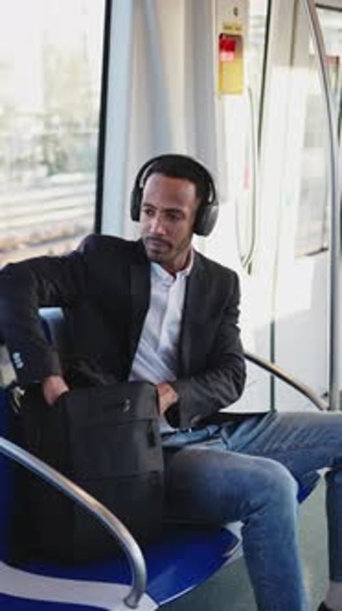 Businessman Working on Laptop and Tablet While Commuting on Subway