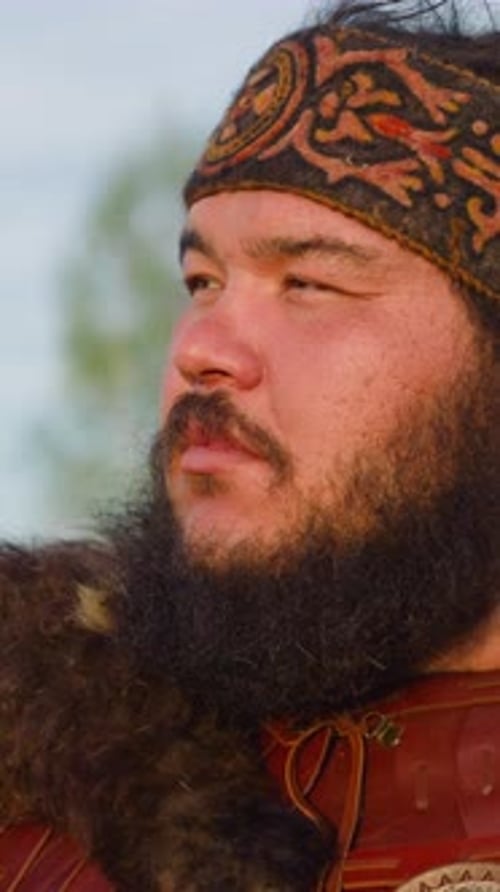 Positive Man with Patterned Headband Looks in Distance