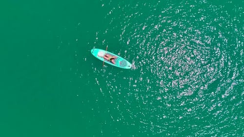Aerial View Paddleboarding Adventure in the Green Canyon People Enjoy the Sun and Relax in Nature