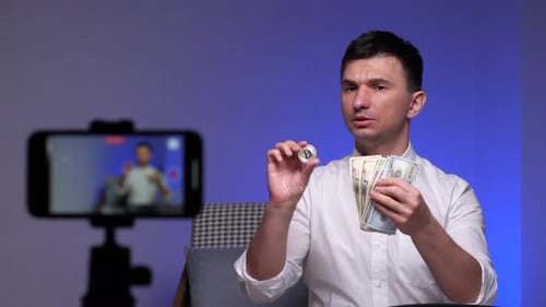 Young Adult Presents Bitcoin and US Currency