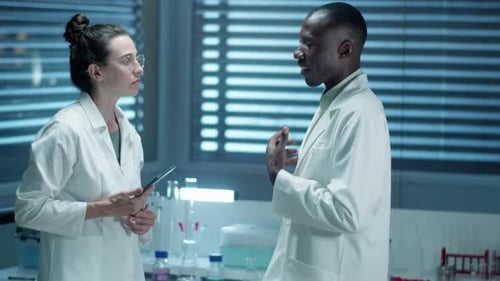 Scientists Discussing Research in Modern Laboratory