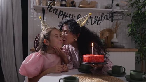 Mother Bringing Birthday Cake to Daughter