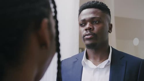 African man talking to African women in corporate office