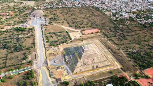 Aerial drone view of the ancient Teotihuacan pyramids with the surrounding Mexican town and mountain