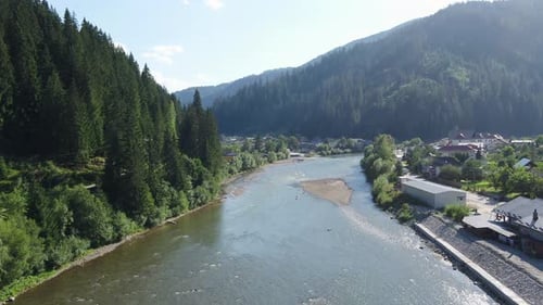 Mountain River Flows Through a Small European Valley Town