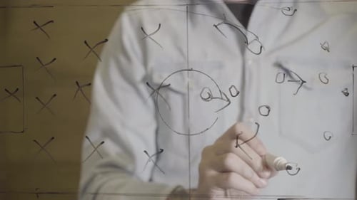 Soccer Manager Drawing Strategy Plan on Glass