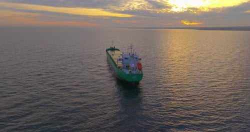 Aerial View of Huge Bulk Carrier Tanker Anchored in Deep Blue Mediterranean Sea at Sunset