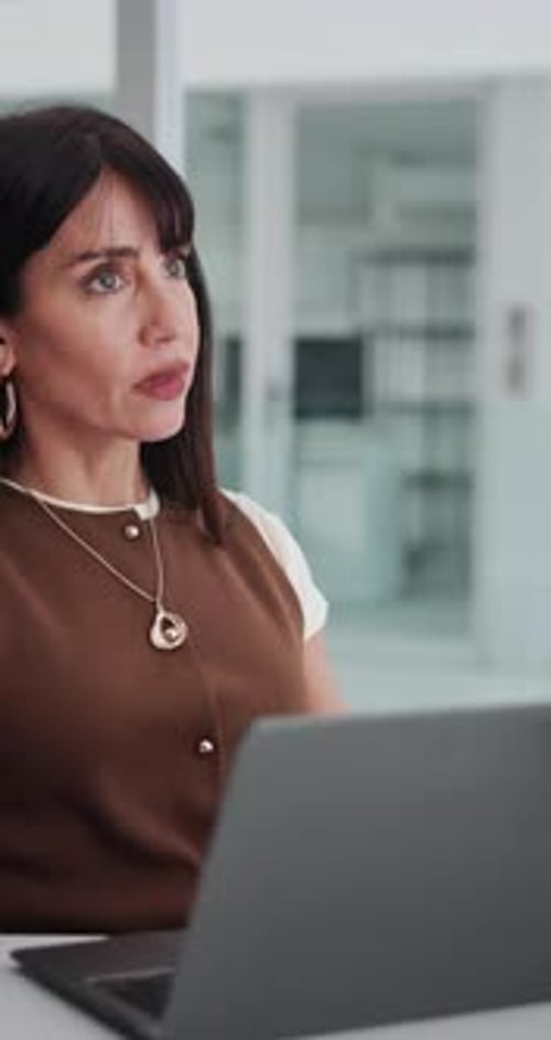 Thinking, office and business woman on laptop for newsletter, article and feedback for online