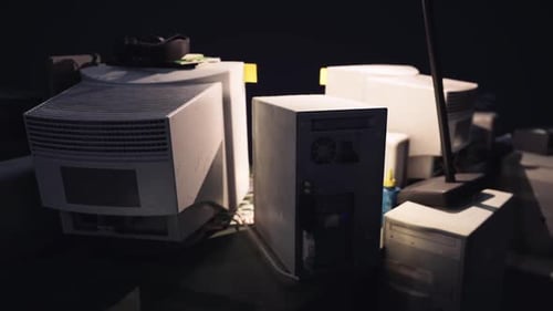 Close Up View of Old Computers and Equipment in a Dimly Lit Room